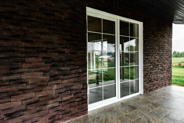 Fototapeta premium Facing the facade made of dark decorative torn bricks.