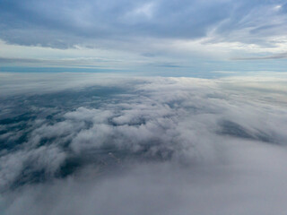 High view of the Dnieper River in Kiev. Aerial high flight above the clouds.