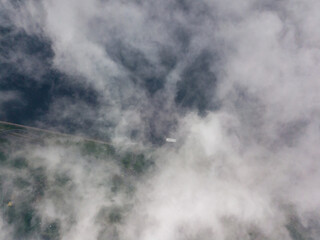 High view of the Dnieper River in Kiev. Aerial high flight above the clouds.