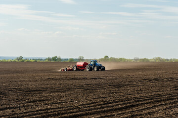 Obraz premium A tractor with cultivator plowing on morning.
