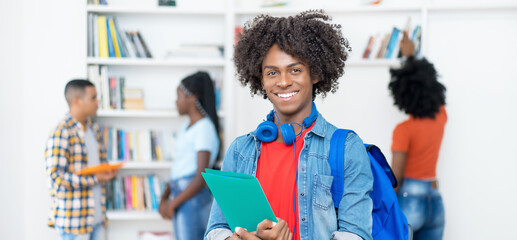 Laughing afro american male college student with copy space
