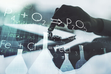 Creative chemistry concept with finger clicks on a digital tablet on background. Multiexposure