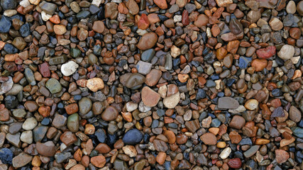 Sea or river multicolored pebbles. Natural texture of beach pebbles. Weathering and erosion of rocks. Drainage systems from small pebbles. Garden drainage for plants and trees. Blue stones for roads.