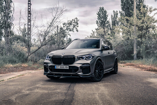 New SUV BMW X5 G05 on the empty road. Kherson, Ukraine - May 2021. 