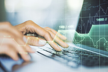 Double exposure of abstract creative statistics data hologram with hands typing on laptop on background, statistics and analytics concept