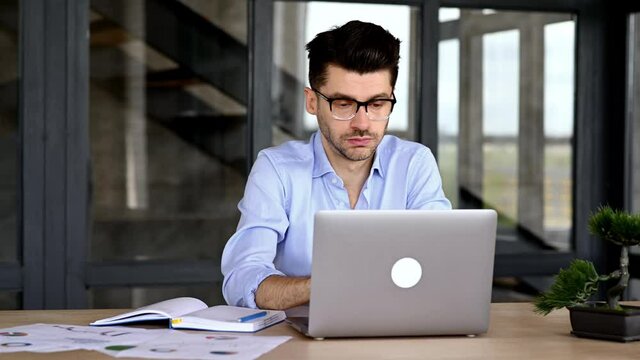 Frustrated exhausted caucasian young adult man, manager, freelancer or office employee, feels tired of many work tasks, in stress, took a break, takes off glasses, need rest, have a headache, migraine