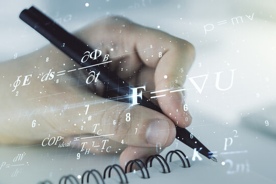 Creative scientific formula hologram with man hand writing in notepad on background, research concept. Multiexposure