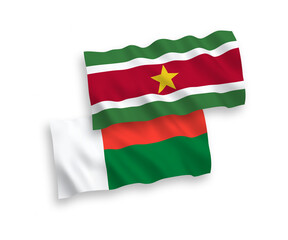 Flags of Republic of Suriname and Madagascar on a white background