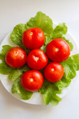 washed ripe tomatoes are cooked for eating on a plate