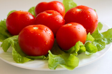 washed ripe tomatoes are cooked for eating on a plate