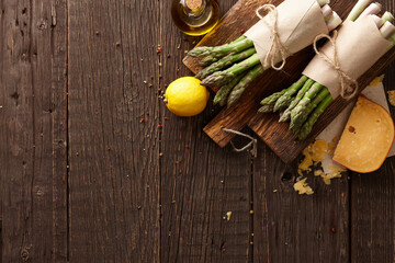 Fresh green asparagus with parmesan cheese on planks