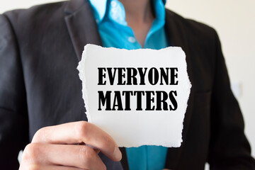 Businessman holding a card with text Everyone matters