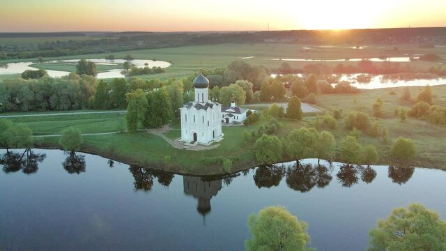 Church of the Intercession on the Nerl in Bogolyubovo, Russia. Famous landmark of the Golden Ring of the Russia. Aerial drone view. Beautiful summer landscape at sunrise. 
