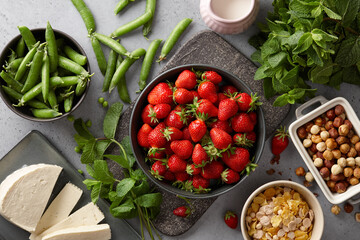 Summer breakfast with fresh strawberries, cheese and granola