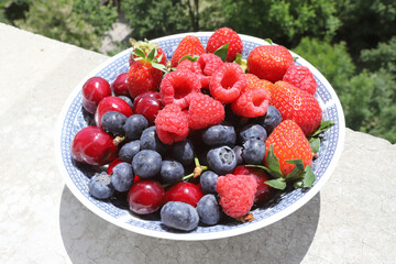 Fresh fruits and berries on daylight