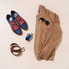 Naklejka premium Flat lay set of stylish male clothes and accessories on wooden background. Top view.