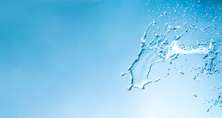 Water splashes with copy space on a blue background