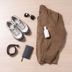 Set of stylish male clothes and accessories on wooden background