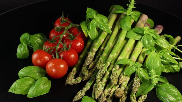 Cherry tomatoes, green basil leaves and asparagus