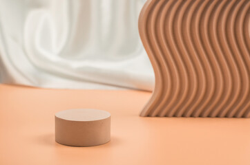 Empty beige podium on a beige background with geometric shapes. Plaster podium for the presentation of cosmetic products