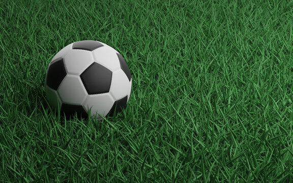 Soccer ball on a green grass of football stadium