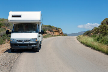 Motor home stopped on the ditch at the curve of the top of the mountain