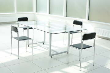 Glass table and chairs in a bright office space