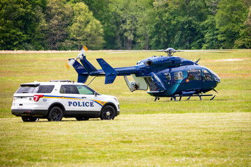 Paramedic helicopter with police car emergency service on the field © PhotoSpirit
