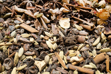 Texture of dry herbal tea with spices and fruits (hibiscus,  star anise flowers and other). Selective focus