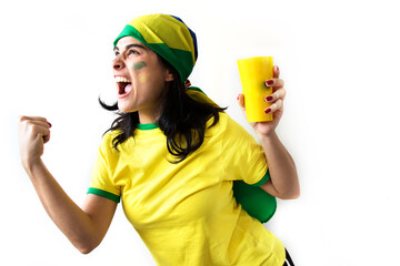 Sport fan Cherring. Beautiful brunette girl in yellow uniform. Woman celebrates sports and game over white background.