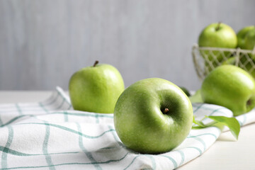 Fresh ripe green apples and napkin on table
