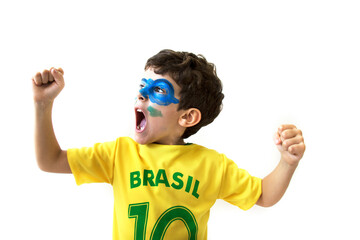 Brazilian boy, soccer player and fan, celebrates making a gesture with his hands over white...