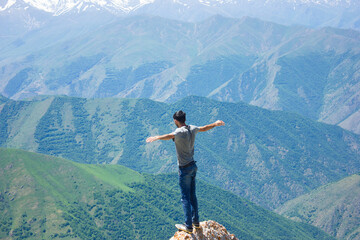 a man standing on the top of a mountain