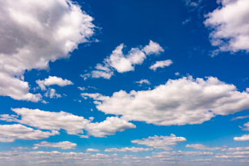 Fototapeta premium Beautiful blue sky with white clouds, aerial photography of the sky. Sunny day. 