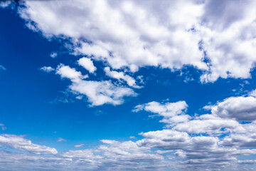 Beautiful blue sky with white clouds, aerial photography of the sky. Sunny day. 
