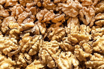 Walnuts with (filling the picture). Background of fresh broken walnuts. Top view blur textures soft focus