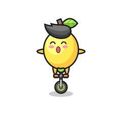 The cute lemon character is riding a circus bike
