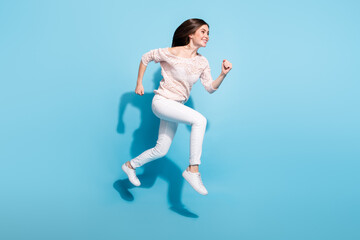 Fototapeta na wymiar Full body profile side photo of excited fast lady jump up run empty space sale isolated on blue color background