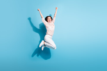 Fototapeta na wymiar Full length photo of excited crazy happy lady jump up raise hands winner isolated on blue color background