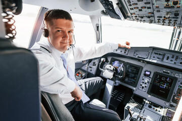 Pilot on the work in the passenger airplane. Preparing for takeoff