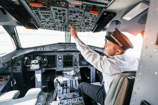 Control of the flight. Pilot on the work in the passenger airplane. Preparing for takeoff