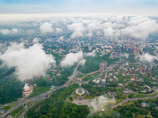 High flight above the clouds in Kiev. Spring morning. Aerial high view.