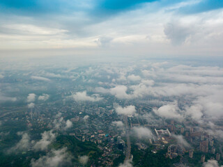High flight above the clouds in Kiev. Spring morning. Aerial high view.