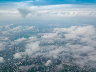 Fototapeta premium High flight above the clouds in Kiev. Spring morning. Aerial high view.