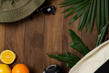sunglasses, fruits and leaves on wooden summer background