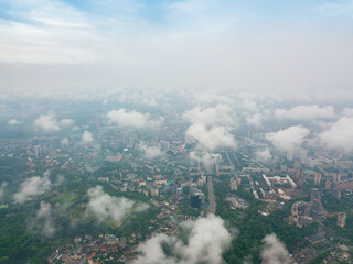 High flight above the clouds in Kiev. Spring morning. Aerial high view.