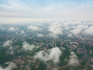 High flight above the clouds in Kiev. Spring morning. Aerial high view.