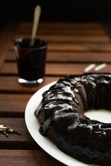 Chocolate cake on black background and an extinguished candle with smoke. Keto diet.