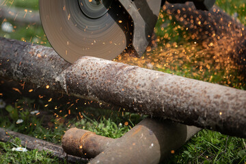 Circular saw saws metal pipes and scrap. Work safety