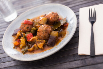 cooked meatballs with stewed eggplant with haze in bowl